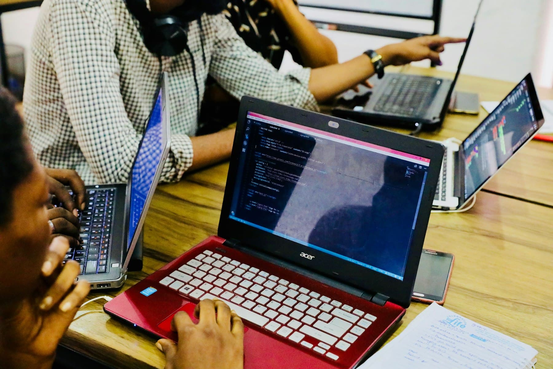 Engineers collaborating on laptops